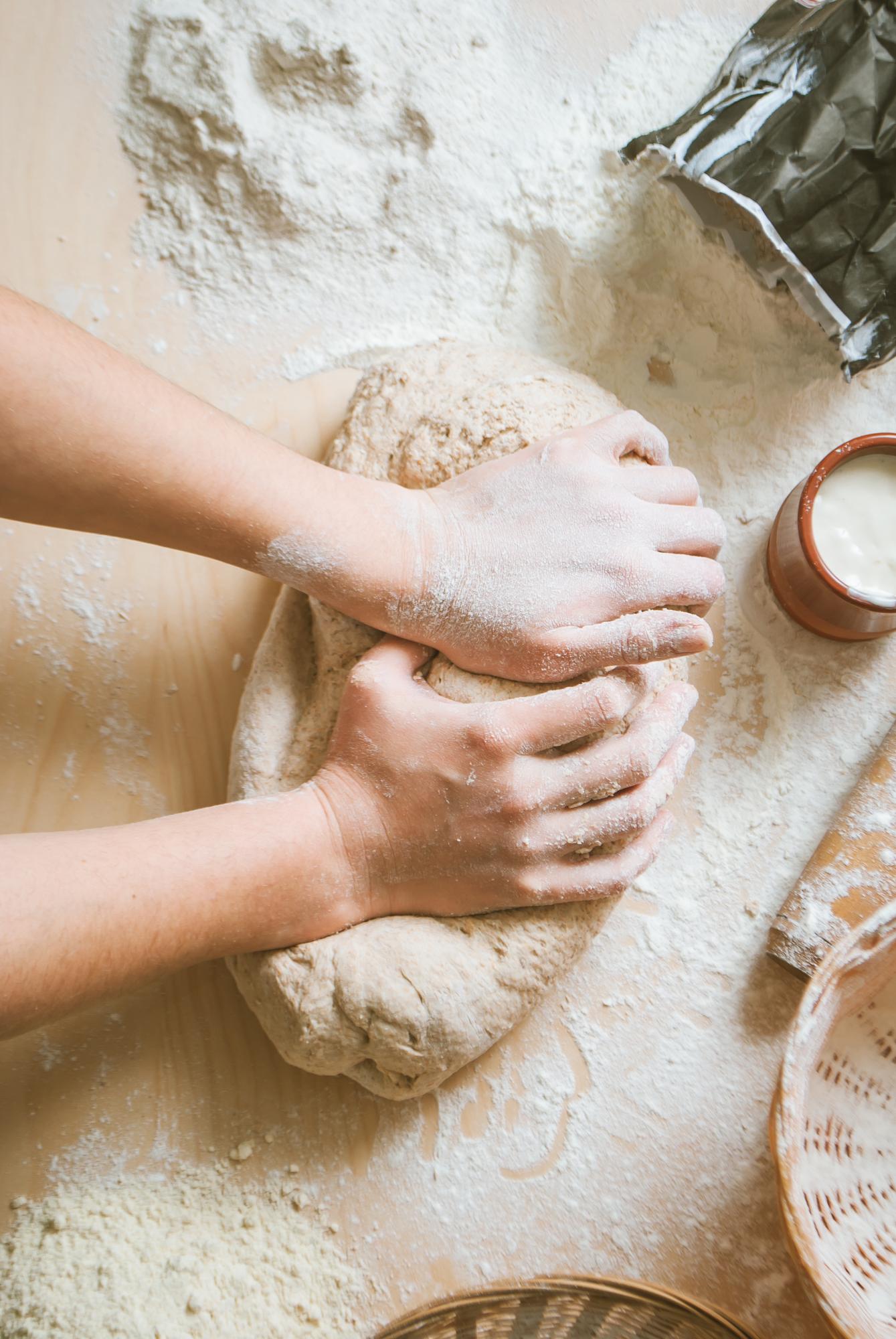 Close-up of hands kneading dough